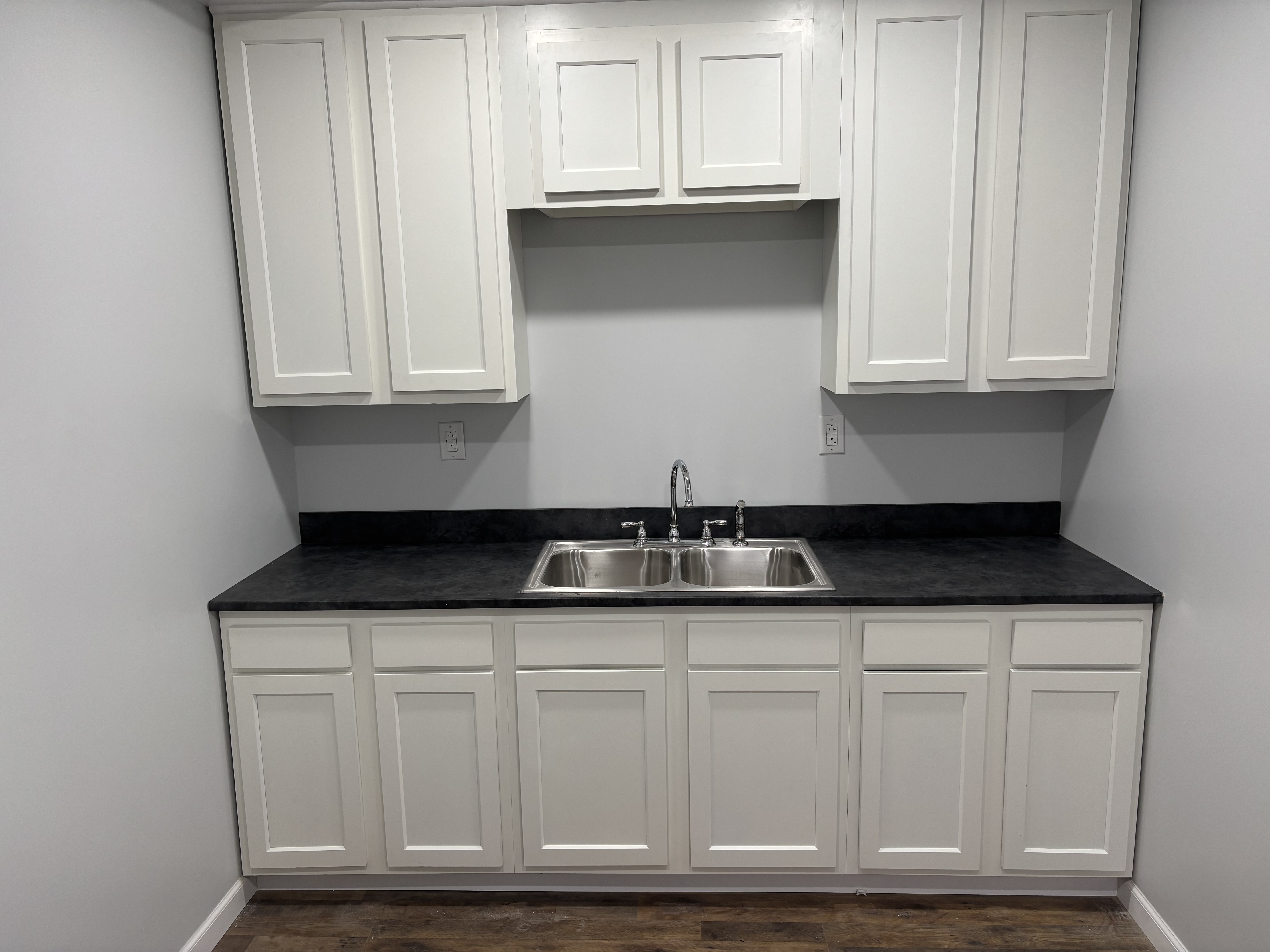 White kitchen cabinetry and sink close-up